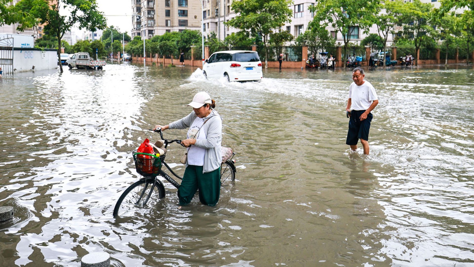 Millions evacuated in China as severe flooding traps villagers and sweeps cars away