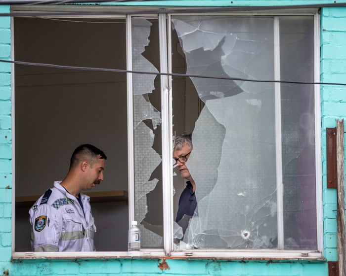 Man arrested after about 50 shots fired from Sydney flat injure bystanders and hit buildings and cars