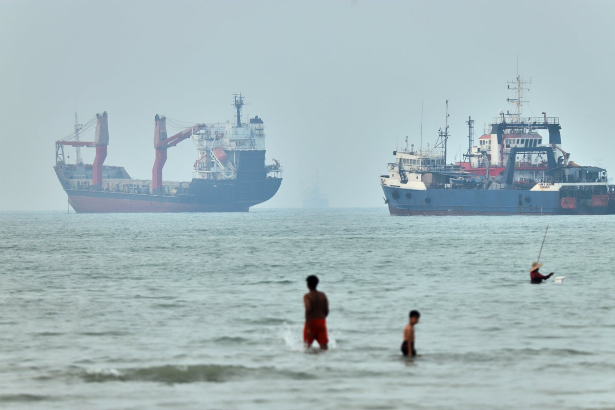 Cargo ship reports being struck in Strait of Hormuz as US, Iran claims about talks diverge
